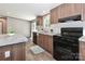 Well-equipped kitchen featuring black appliances and wood cabinets at 1380 St. Johns Church Rd, Concord, NC 28025