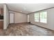 Bright living room with wood-look floors and natural light from the windows at 1380 St. Johns Church Rd, Concord, NC 28025