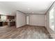 Open-concept living room flowing into the kitchen with modern vinyl flooring throughout at 1380 St. Johns Church Rd, Concord, NC 28025