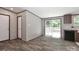 Spacious living room with wood-look flooring and sliding glass doors to balcony at 1380 St. Johns Church Rd, Concord, NC 28025