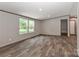 Spacious living room with modern flooring, neutral walls, and windows with a view at 1380 St. Johns Church Rd, Concord, NC 28025