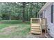 Newly-built wooden porch in a large yard with mature trees and the side of a gray home at 1380 St. Johns Church Rd, Concord, NC 28025