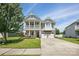 Inviting two-story home featuring a charming porch, a two car garage, and manicured lawn at 1437 Imperial Ct, York, SC 29745