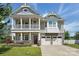 Inviting two-story home featuring a charming porch, a two car garage, and manicured lawn at 1437 Imperial Ct, York, SC 29745