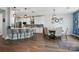 Open concept kitchen features an island with breakfast bar and adjacent dining area with stylish lighting at 1437 Imperial Ct, York, SC 29745