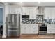 Stainless steel refrigerator and gas range complement the white cabinets in this modern kitchen at 1437 Imperial Ct, York, SC 29745