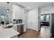 Kitchen area featuring white cabinets and stainless steel dishwasher with adjacent doorway and hallway at 1437 Imperial Ct, York, SC 29745