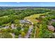 Aerial view of neighborhood clubhouse with parking and golf course, set amid lush greenery and residential homes at 14505 Sunset Walk Ln, Huntersville, NC 28078