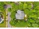 Overhead view of a house surrounded by lush trees, showing its private setting and proximity to neighborhood streets at 14505 Sunset Walk Ln, Huntersville, NC 28078