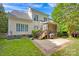 Spacious backyard featuring a screened-in porch, patio, and lush green lawn perfect for outdoor entertaining at 14505 Sunset Walk Ln, Huntersville, NC 28078