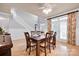 Elegant dining room boasts hardwood floors, a large table, and French doors with decorative curtains at 14505 Sunset Walk Ln, Huntersville, NC 28078