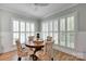Dining room with lots of natural light, decorative chairs, round wooden table and hardwood floors at 14505 Sunset Walk Ln, Huntersville, NC 28078