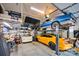 Organized garage with car lift showcasing classic cars, perfect for auto enthusiasts and hobbyists at 14505 Sunset Walk Ln, Huntersville, NC 28078