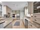 Bright kitchen with stainless steel appliances, granite counters, light wood floors and white cabinets at 14505 Sunset Walk Ln, Huntersville, NC 28078