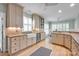 Kitchen featuring white cabinets, stainless steel appliances, light hardwood floors and breakfast nook at 14505 Sunset Walk Ln, Huntersville, NC 28078