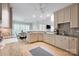 Well-lit kitchen with custom cabinets, countertops, and hardwood floors next to breakfast area and living room at 14505 Sunset Walk Ln, Huntersville, NC 28078