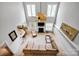 Aerial view of open concept living room with leather sofa, ceiling fan, and adjacent dining and kitchen area at 14505 Sunset Walk Ln, Huntersville, NC 28078