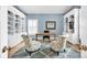 Bright office with custom built-in bookshelves, a comfortable seating area, and a calming color scheme at 14505 Sunset Walk Ln, Huntersville, NC 28078