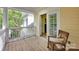 Cozy porch with wood flooring, rocking chair, and relaxing view of the landscaped yard at 14505 Sunset Walk Ln, Huntersville, NC 28078