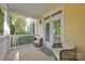 Inviting covered porch features comfortable seating, creating a relaxing outdoor space at 14505 Sunset Walk Ln, Huntersville, NC 28078