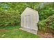 A charming shed nestled amidst greenery, providing ample storage and enhancing the landscape at 14505 Sunset Walk Ln, Huntersville, NC 28078