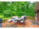 Spacious outdoor deck surrounded by lush greenery, perfect for dining and relaxing with nature at 151 Deja Ln, Cleveland, NC 27013