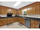 Traditional kitchen boasts wood cabinetry, granite countertops, and stainless steel dishwasher at 151 Deja Ln, Cleveland, NC 27013