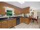 Charming kitchen featuring wood cabinets, stainless dishwasher and an adjacent dining area at 151 Deja Ln, Cleveland, NC 27013