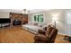 Inviting living room with hardwood floors, brick fireplace, and natural light from a sliding glass door at 151 Deja Ln, Cleveland, NC 27013