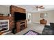 Cozy living room featuring a brick fireplace, ceiling fan, and carpeted floors at 151 Deja Ln, Cleveland, NC 27013