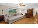 Bright living room featuring hardwood floors, a large couch, and a view of the backyard at 151 Deja Ln, Cleveland, NC 27013