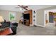 Comfortable living room with a brick fireplace, a modern TV and a ceiling fan at 151 Deja Ln, Cleveland, NC 27013