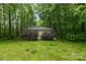 Outbuilding surrounded by trees, grass and shrubbery in a verdant outdoor space at 151 Deja Ln, Cleveland, NC 27013