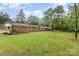 Spacious backyard of brick house with lush green lawn and mature trees at 16 Green St, York, SC 29745