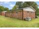 Back view of the brick home with green grass and AC unit in the yard at 16 Green St, York, SC 29745