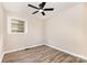 View of a bedroom with a ceiling fan and neutral walls, and wood look flooring at 16 Green St, York, SC 29745