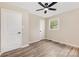 View of a bedroom with a ceiling fan and neutral walls, and wood look flooring at 16 Green St, York, SC 29745