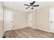 View of a bedroom with a ceiling fan and neutral walls, and wood look flooring at 16 Green St, York, SC 29745