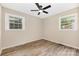 View of a bedroom with a ceiling fan and neutral walls, and wood look flooring at 16 Green St, York, SC 29745