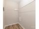 Image of closet space with rack and neutral colored walls, and wood look flooring at 16 Green St, York, SC 29745