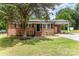 Charming single-story brick house with well-maintained lawn and mature trees at 16 Green St, York, SC 29745