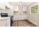 Well-lit kitchen with updated appliances, white cabinets, and countertops, creating a functional space at 16 Green St, York, SC 29745