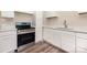 Close up of the modern kitchen with stainless steel oven, white cabinets and hard surface countertops at 16 Green St, York, SC 29745
