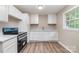 Updated kitchen with new stainless steel appliances, white cabinets and lots of countertop space at 16 Green St, York, SC 29745