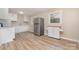 Bright kitchen featuring white cabinets, stainless steel refrigerator, and spacious layout at 16 Green St, York, SC 29745