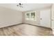 Bright living room with sleek flooring, fresh paint, and natural light from a large window at 16 Green St, York, SC 29745