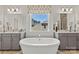 Luxurious bathroom features a soaking tub beneath a window, surrounded by dual vanities at 162 Nicholson Ln, Mooresville, NC 28115