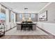 Bright dining room with wainscoting, chandelier, hardwood floors, and lots of natural light at 162 Nicholson Ln, Mooresville, NC 28115