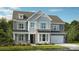 Charming two-story home with stone accents, gray siding, and a well-manicured front lawn at 162 Nicholson Ln, Mooresville, NC 28115