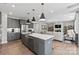 Spacious kitchen with granite island and stainless steel appliances open to living area at 162 Nicholson Ln, Mooresville, NC 28115